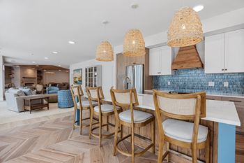a kitchen with a bar with chairs and a dining tableat Oak Grove at Blake Farm, Wilmington, North Carolina